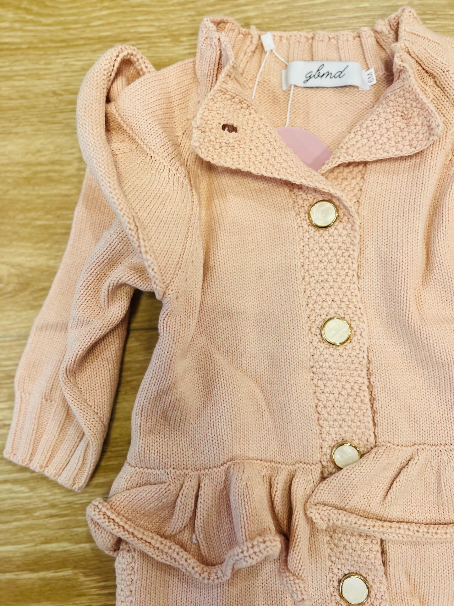 Light pink romper with buttons/ruffles