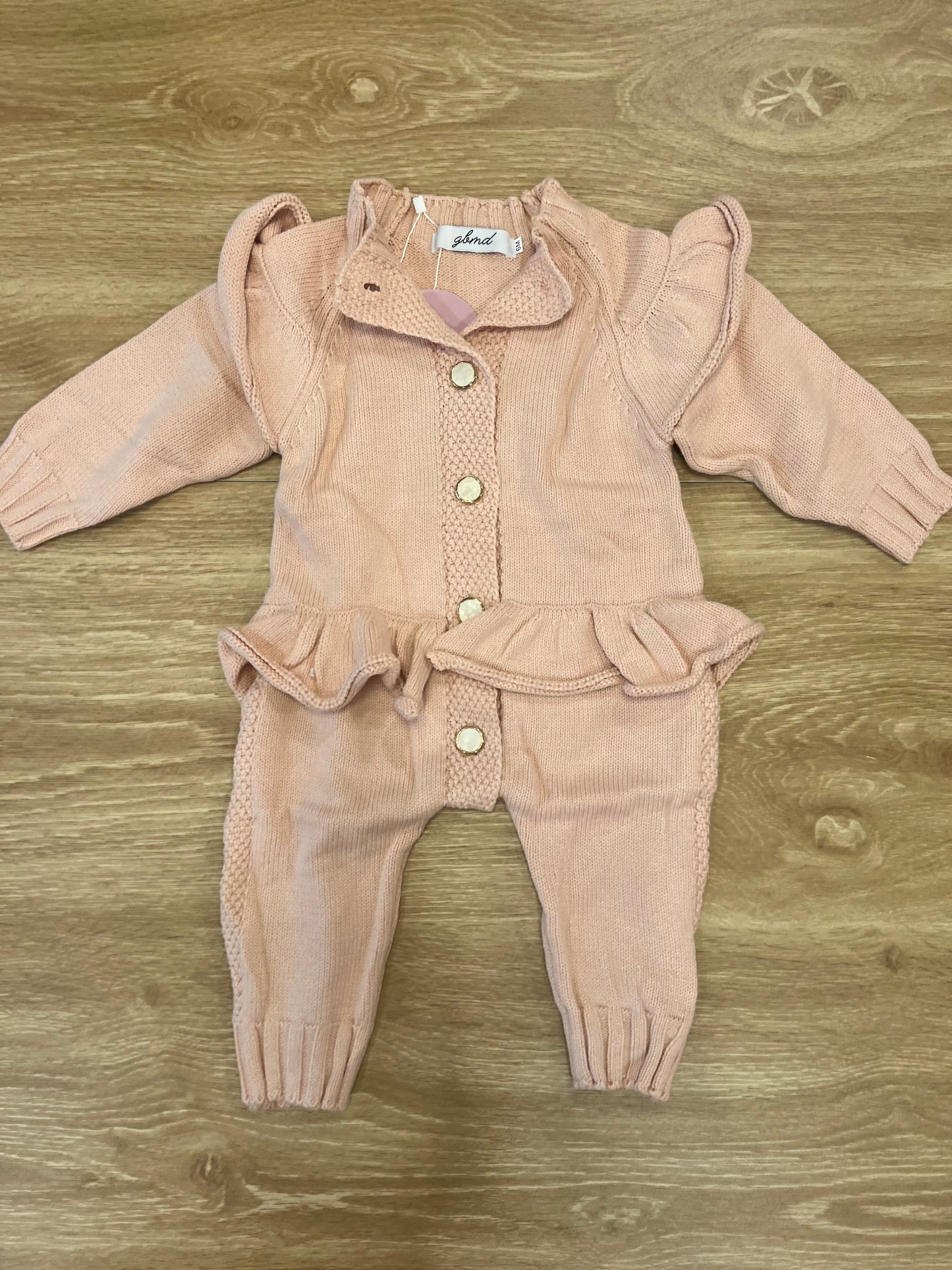 Light pink romper with buttons/ruffles